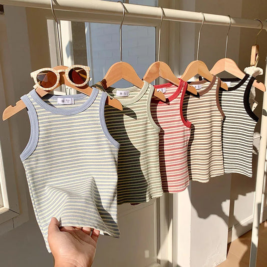 Set of striped tank tops on hangers with a hand holding one, against a neutral background.